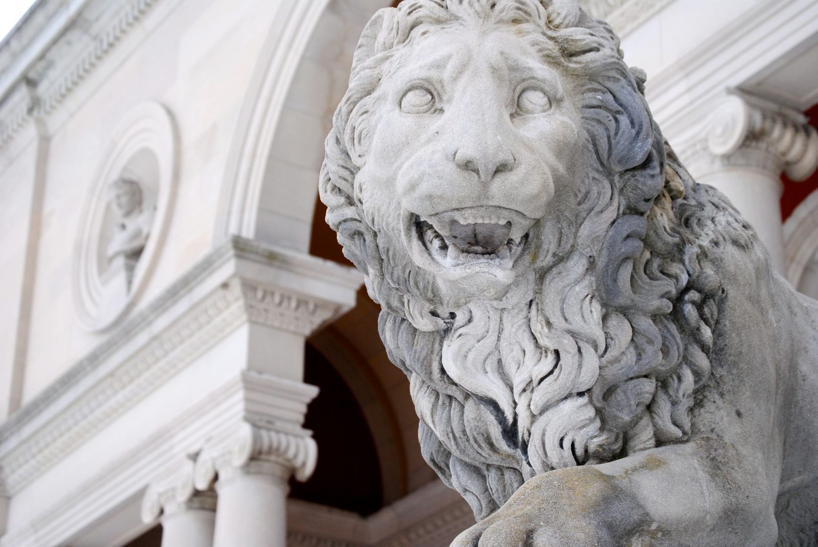 Majestic marble lion sculpture at a historic building in Brunswick, Maine
